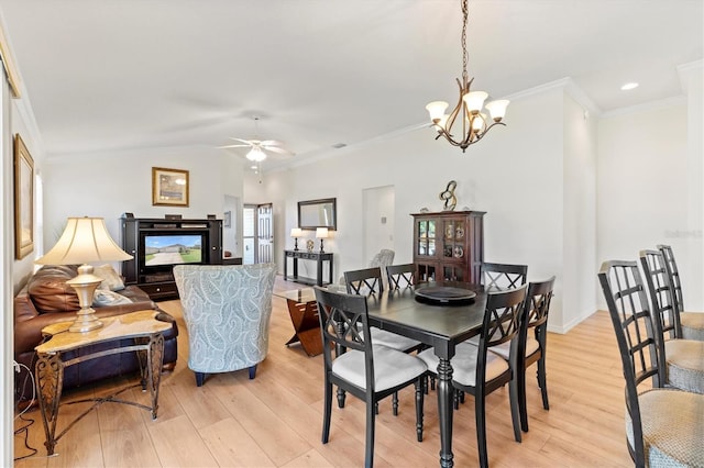 dining area featuring vaulted ceiling, recessed lighting, light wood-style floors, ceiling fan with notable chandelier, and crown molding
