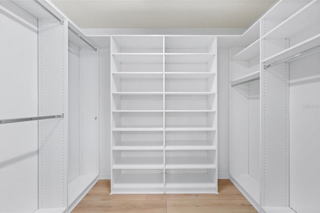 walk in closet featuring light wood finished floors