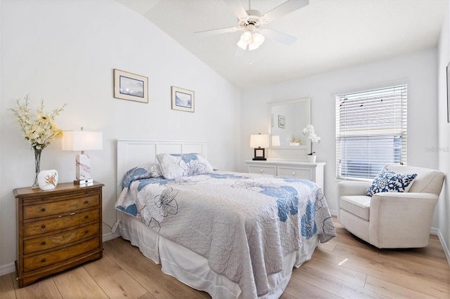 bedroom with light wood-type flooring, ceiling fan, baseboards, and lofted ceiling