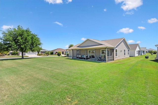 back of house with a sunroom and a yard
