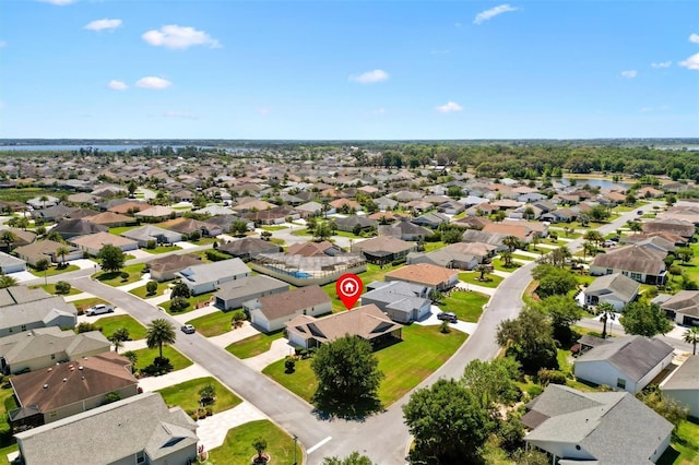 drone / aerial view with a water view and a residential view