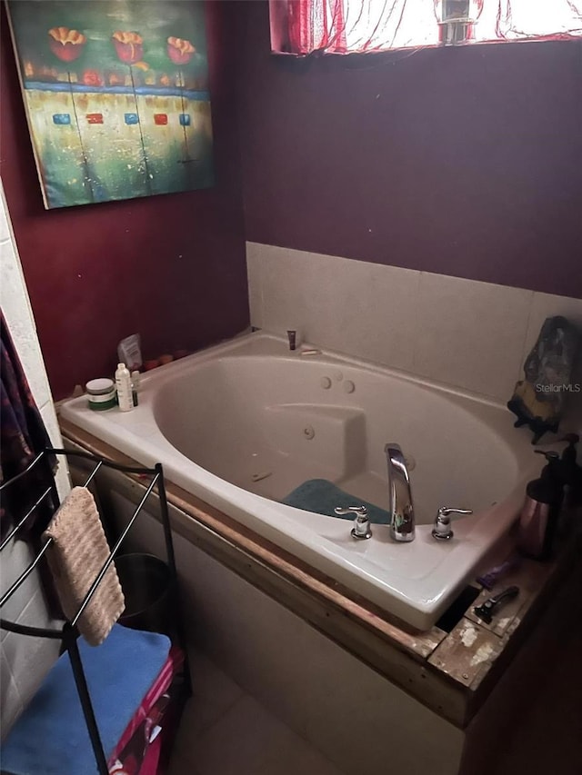 full bathroom featuring tile patterned floors and a tub with jets