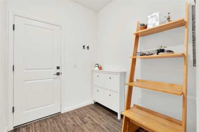 interior space featuring baseboards and wood finished floors
