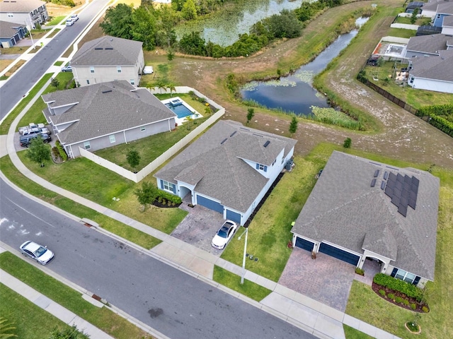 drone / aerial view with a water view and a residential view