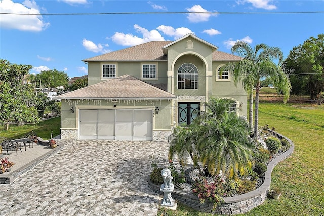54 Andora Ct, Kissimmee, FL 34758 - view of front facade with roof with shingles, a front lawn, a garage, and stucco siding