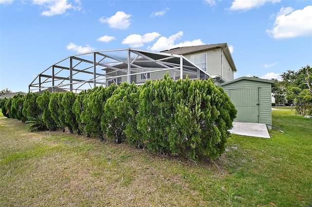 54 Andora Ct, Kissimmee, FL 34758 - exterior space featuring stucco siding, an outdoor structure, a shed, a lanai, and a lawn