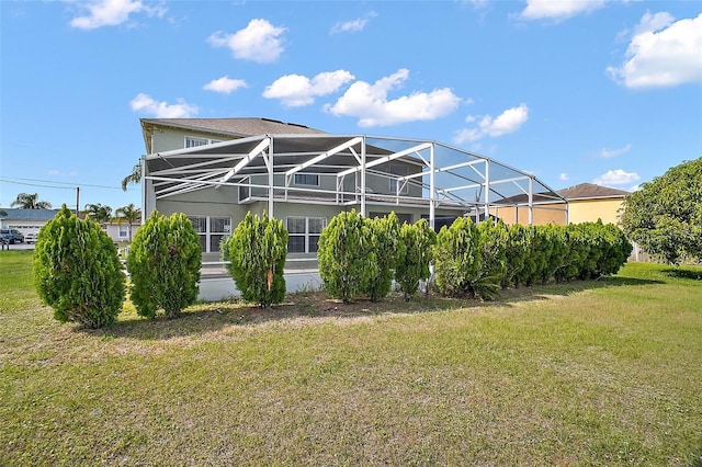 54 Andora Ct, Kissimmee, FL 34758 - rear view of property featuring stucco siding, a lanai, and a lawn