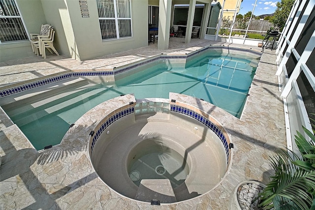 54 Andora Ct, Kissimmee, FL 34758 - view of pool featuring a patio area, a pool with connected hot tub, and glass enclosure