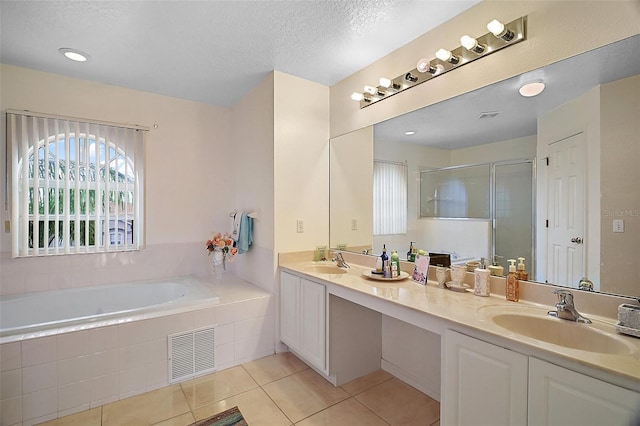 54 Andora Ct, Kissimmee, FL 34758 - bathroom with a shower stall, tile patterned floors, visible vents, and a sink
