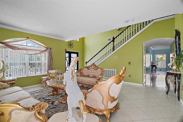 54 Andora Ct, Kissimmee, FL 34758 - tiled living area featuring visible vents, baseboards, and crown molding