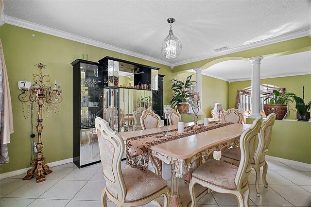 54 Andora Ct, Kissimmee, FL 34758 - dining area featuring crown molding, light tile patterned floors, ornate columns, arched walkways, and baseboards