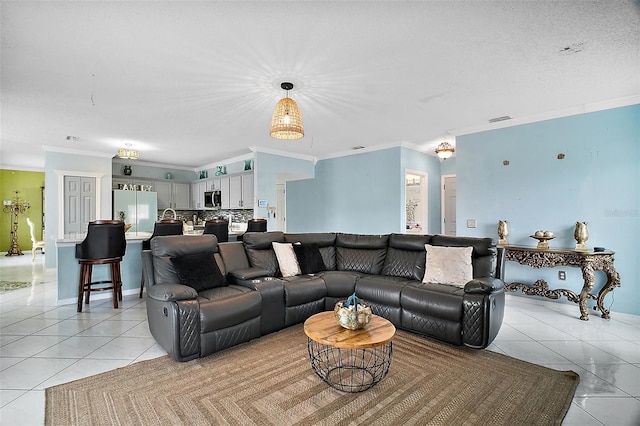 54 Andora Ct, Kissimmee, FL 34758 - living room with visible vents, ornamental molding, and light tile patterned flooring