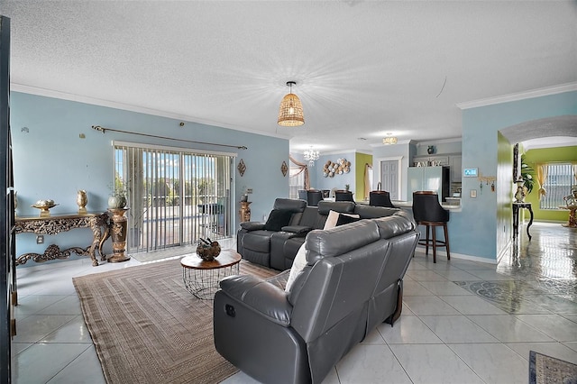 54 Andora Ct, Kissimmee, FL 34758 - living area featuring crown molding, light tile patterned floors, arched walkways, and a healthy amount of sunlight