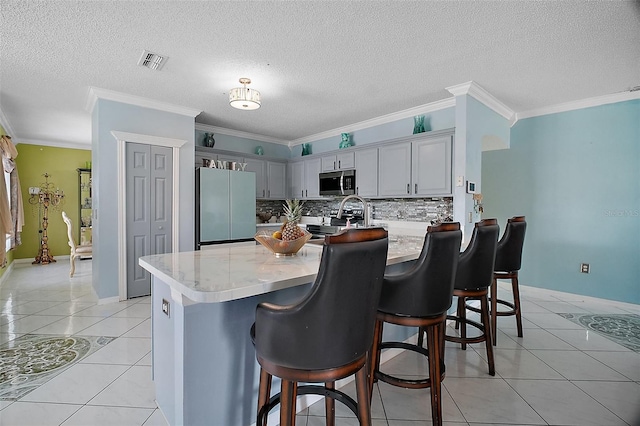 54 Andora Ct, Kissimmee, FL 34758 - kitchen with freestanding refrigerator, a peninsula, visible vents, stainless steel microwave, and light countertops