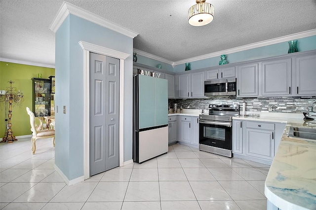54 Andora Ct, Kissimmee, FL 34758 - kitchen featuring stainless steel appliances, a textured ceiling, backsplash, and gray cabinets