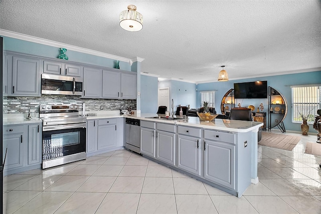 54 Andora Ct, Kissimmee, FL 34758 - kitchen with stainless steel appliances, a peninsula, open floor plan, and gray cabinets