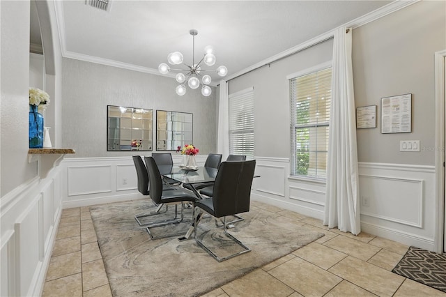 tiled dining room featuring a decorative wall, ornamental molding, a wainscoted wall, and a chandelier
