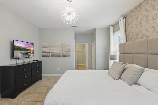 bedroom featuring visible vents, baseboards, and a chandelier