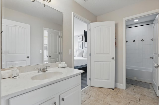 ensuite bathroom featuring tile patterned floors, vanity, ensuite bath, and tub / shower combination
