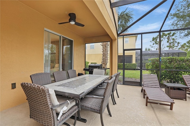 sunroom / solarium with outdoor dining space and a ceiling fan