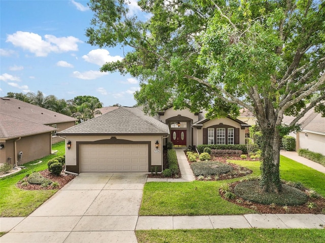 single story home with a front yard, a garage, stucco siding, driveway, and roof with shingles