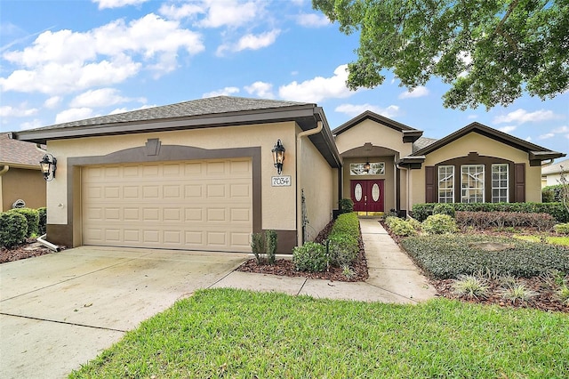 view of front of property with concrete driveway, a garage, and stucco siding