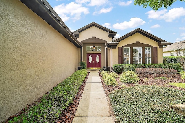 property entrance featuring stucco siding