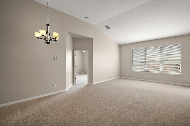 spare room with baseboards, a chandelier, visible vents, lofted ceiling, and light colored carpet