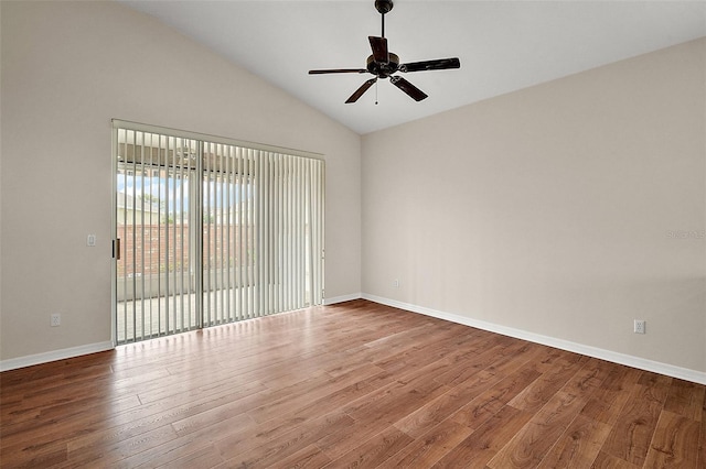 unfurnished room featuring baseboards, a ceiling fan, vaulted ceiling, and wood finished floors