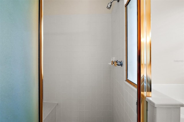 bathroom with a tile shower