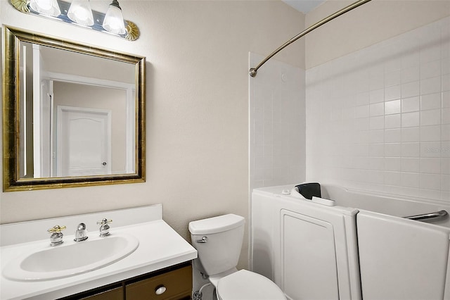 bathroom featuring vanity, toilet, and tub / shower combination