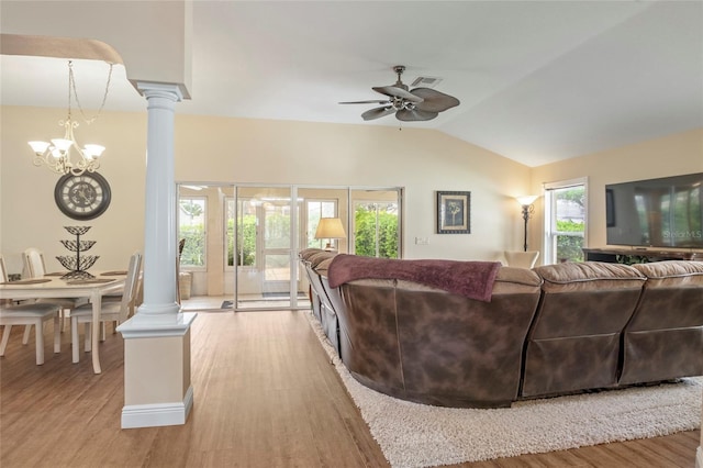 living area featuring visible vents, wood finished floors, ceiling fan with notable chandelier, lofted ceiling, and ornate columns