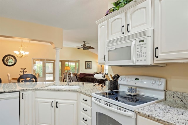 kitchen featuring white appliances, white cabinets, a sink, and ceiling fan with notable chandelier