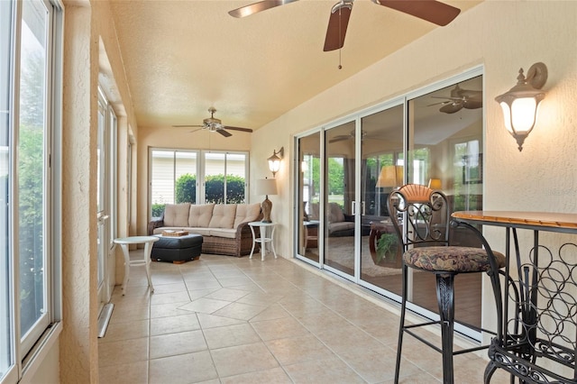 sunroom / solarium with tile patterned floors and a textured wall