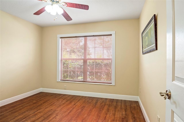 empty room featuring a ceiling fan, baseboards, and wood finished floors