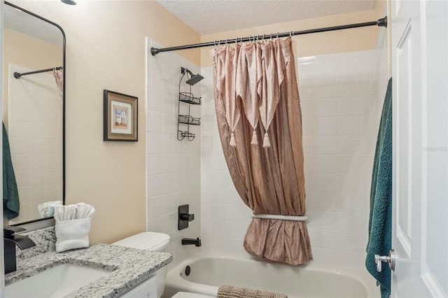 bathroom with vanity, toilet, a textured ceiling, and shower / bath combination with curtain