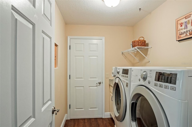 clothes washing area featuring laundry area, a textured ceiling, washing machine and dryer, baseboards, and dark wood-type flooring