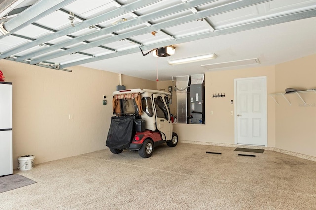 garage featuring heating unit and a garage door opener