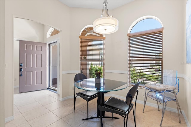 dining area with light tile patterned floors and baseboards