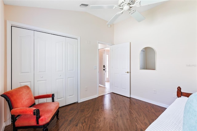 bedroom with visible vents, baseboards, a closet, wood finished floors, and lofted ceiling