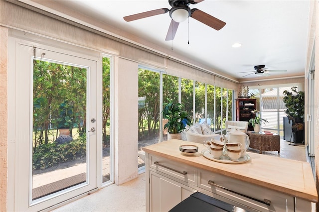 sunroom / solarium with ceiling fan and plenty of natural light