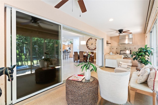 tiled living area featuring ceiling fan and recessed lighting