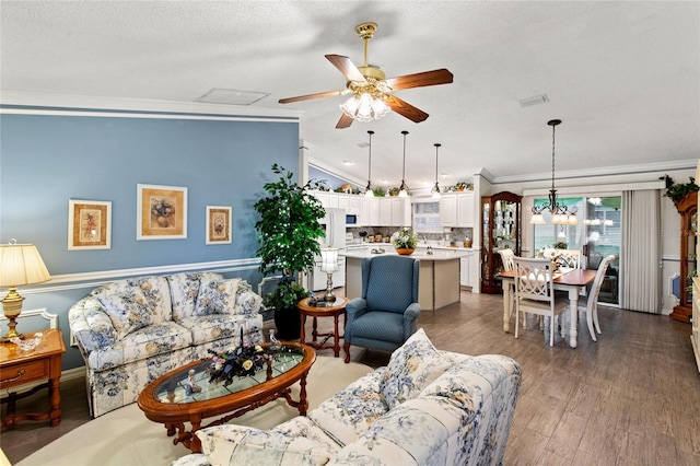 1526 Blueberry Way, The Villages, FL 32162 - living area with ornamental molding, ceiling fan, wood finished floors, and a textured ceiling