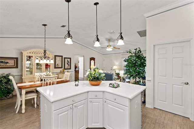 1526 Blueberry Way, The Villages, FL 32162 - kitchen with crown molding, ceiling fan with notable chandelier, light wood finished floors, and light countertops