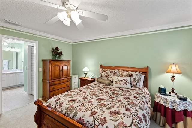 1526 Blueberry Way, The Villages, FL 32162 - bedroom featuring ensuite bathroom, visible vents, ornamental molding, ceiling fan, and a textured ceiling