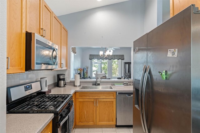791 Wolf Creek St, Clermont, FL 34711 - kitchen featuring appliances with stainless steel finishes, light countertops, a chandelier, decorative backsplash, and light tile patterned flooring