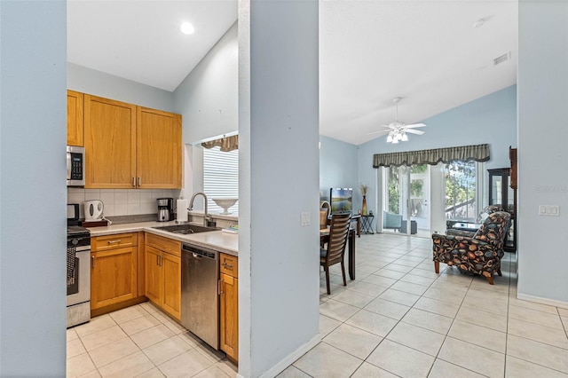 791 Wolf Creek St, Clermont, FL 34711 - kitchen with appliances with stainless steel finishes, high vaulted ceiling, light tile patterned flooring, tasteful backsplash, and light countertops