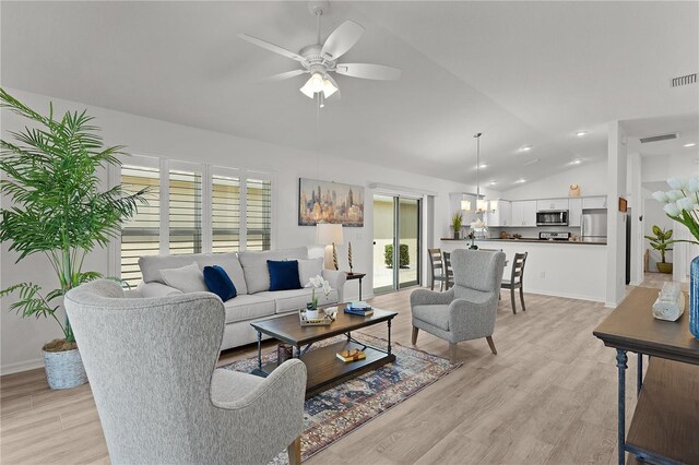 living room with visible vents, light wood-style flooring, a ceiling fan, and lofted ceiling