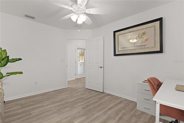 office with light wood-style floors, baseboards, a ceiling fan, and visible vents
