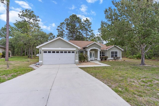 17 Eugenia Ct N, Homosassa, FL 34446 - ranch-style house with an attached garage, concrete driveway, stucco siding, and a front yard